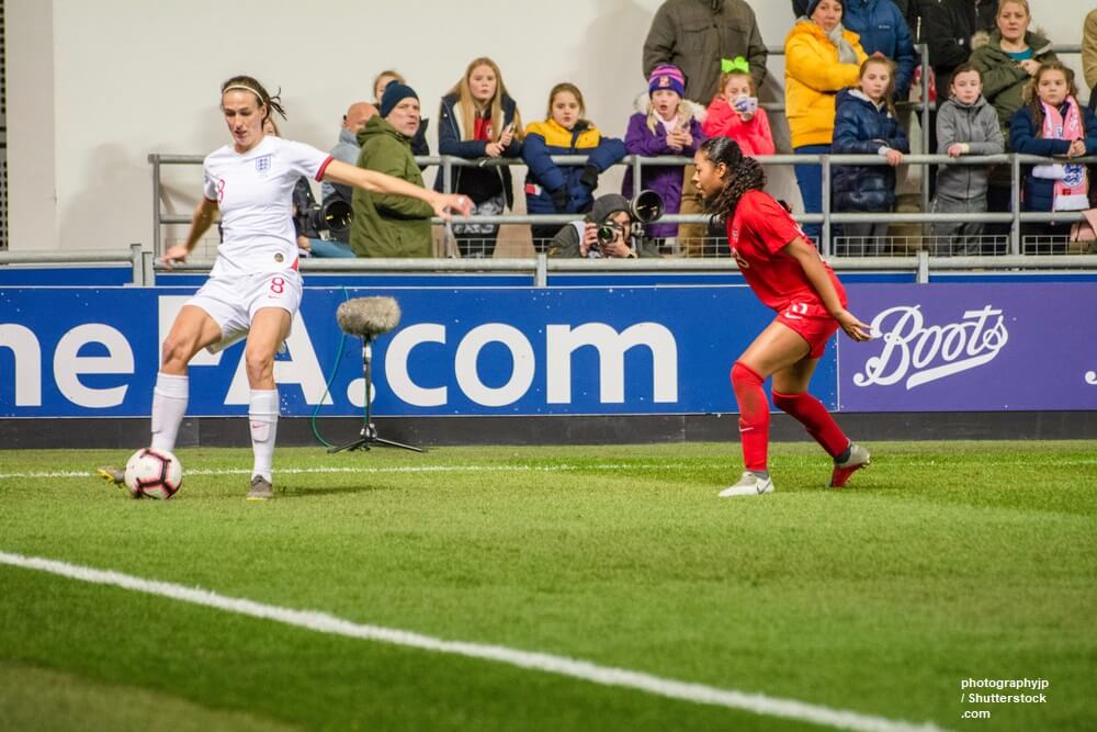 England's Jill Scott holds the ball up from Jayde Riviere (Canada)